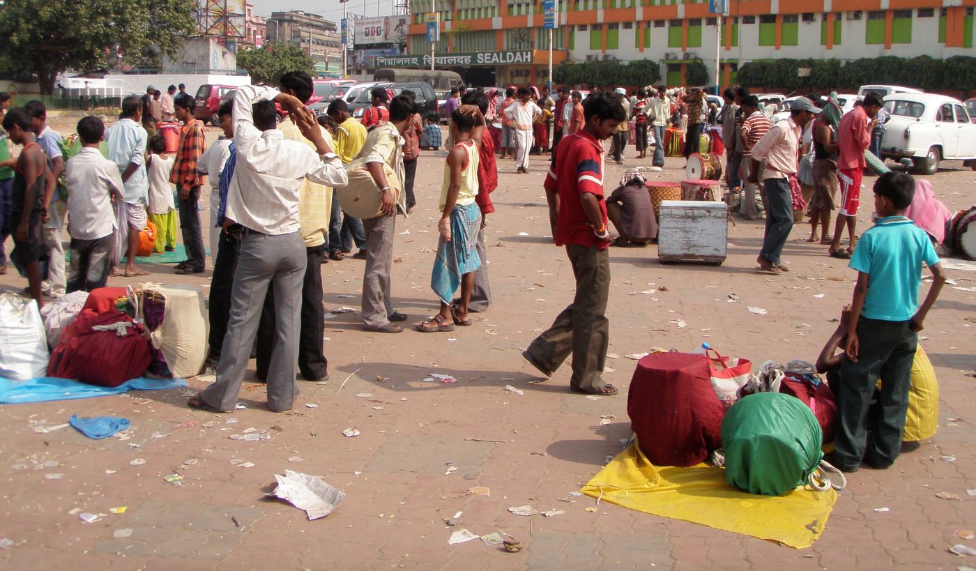 Dhakis with their wrapped drums waiting on the forecourt of Sealdah station